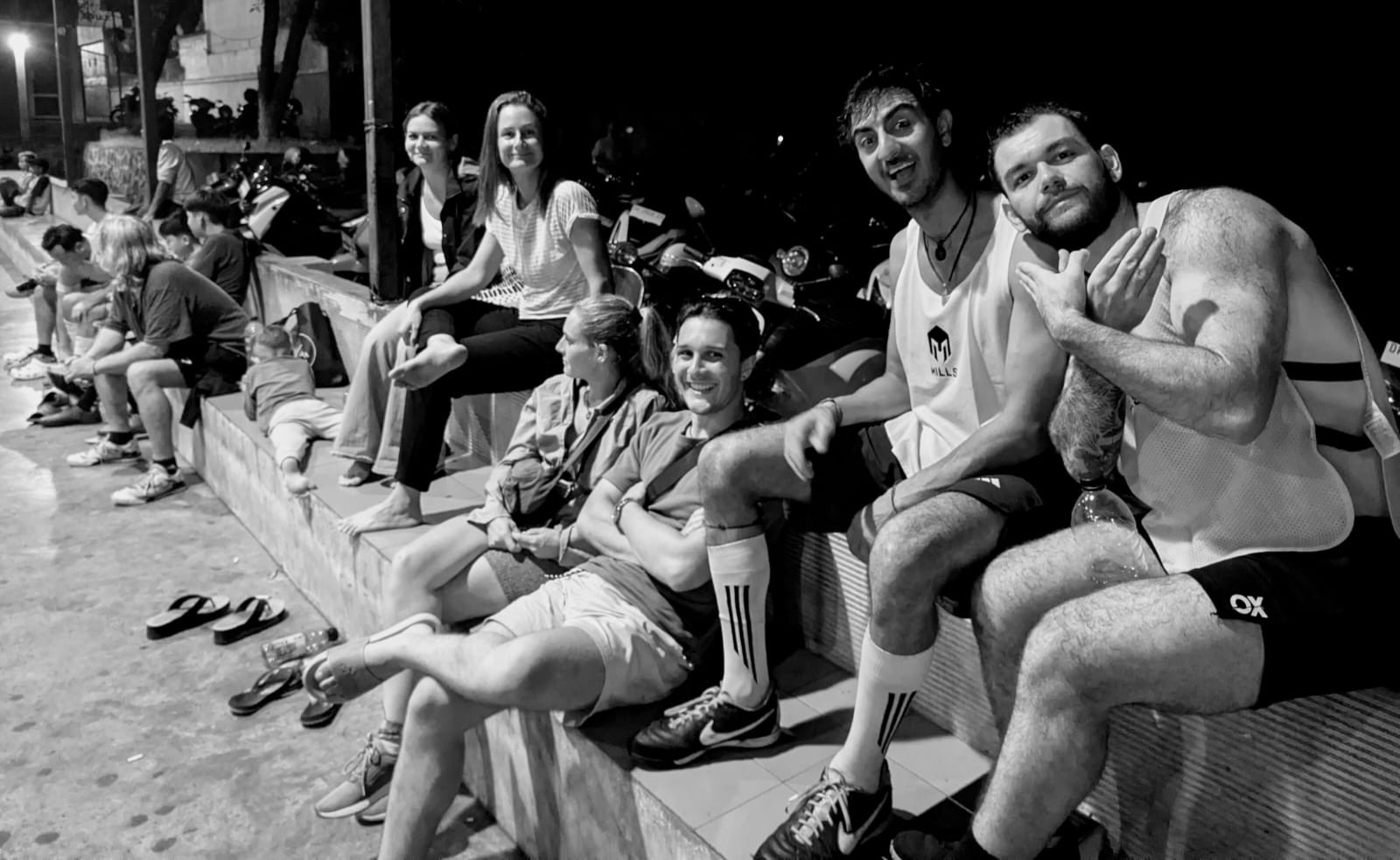 Teammates relaxing on the steps after training